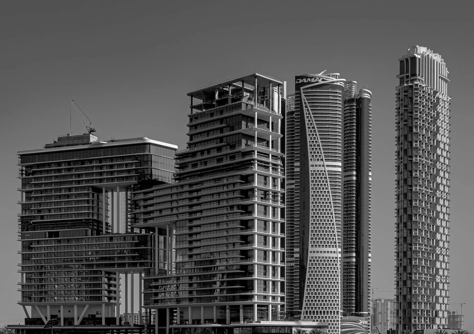 A black and white photo of some very tall buildings