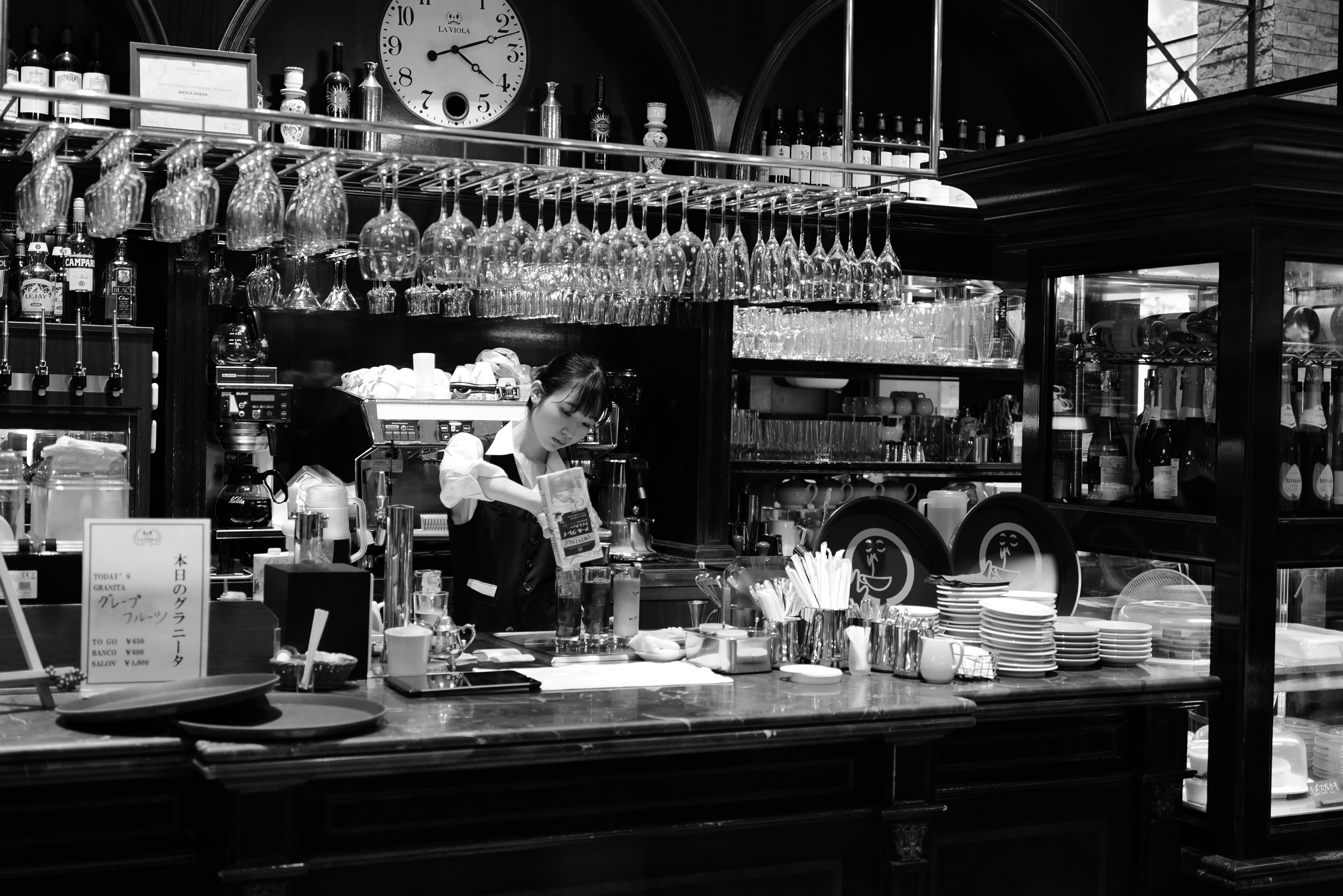 A black and white photo of a restaurant counter
