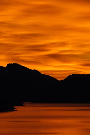 A large body of water with mountains in the background