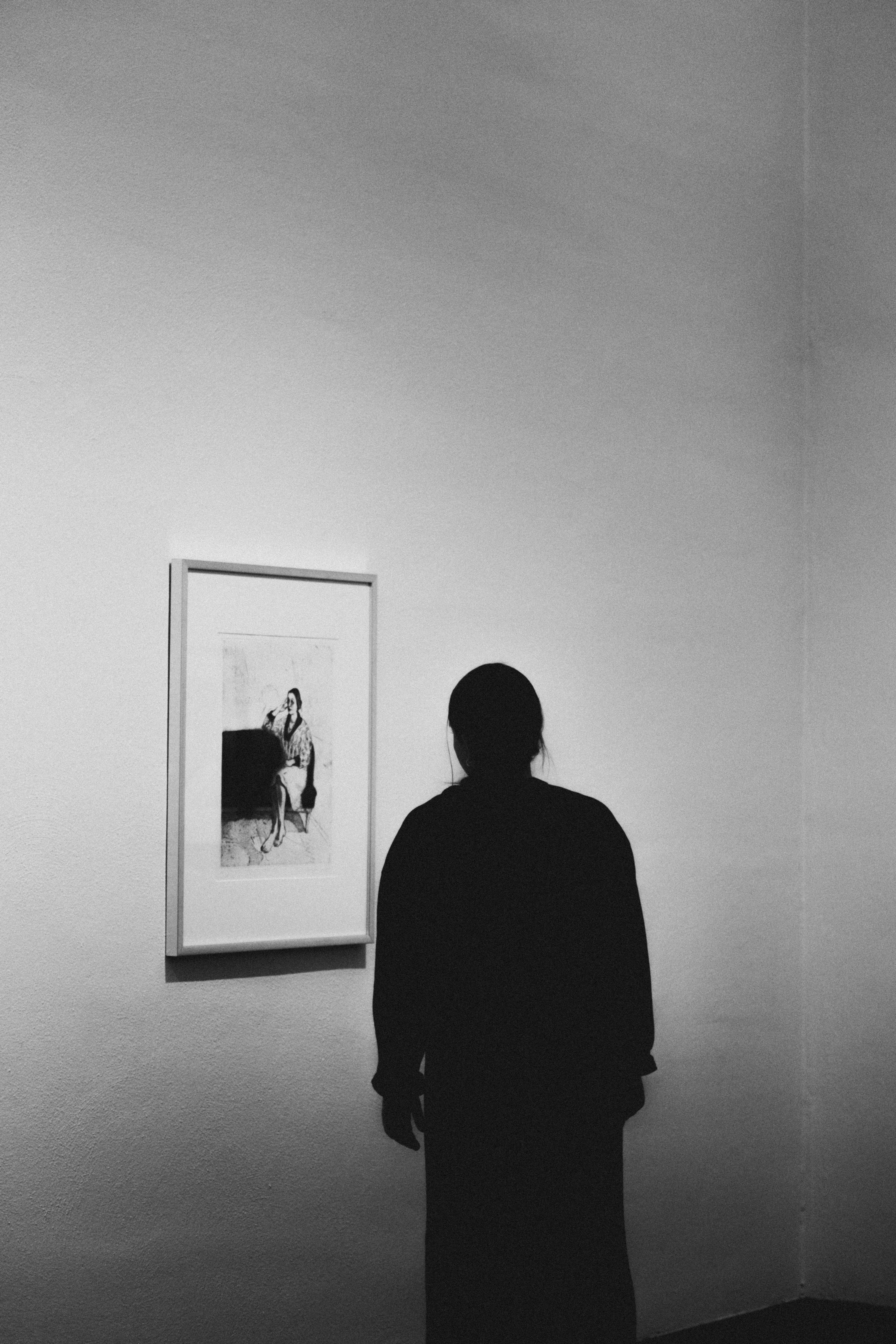 A man standing in front of a painting on a wall