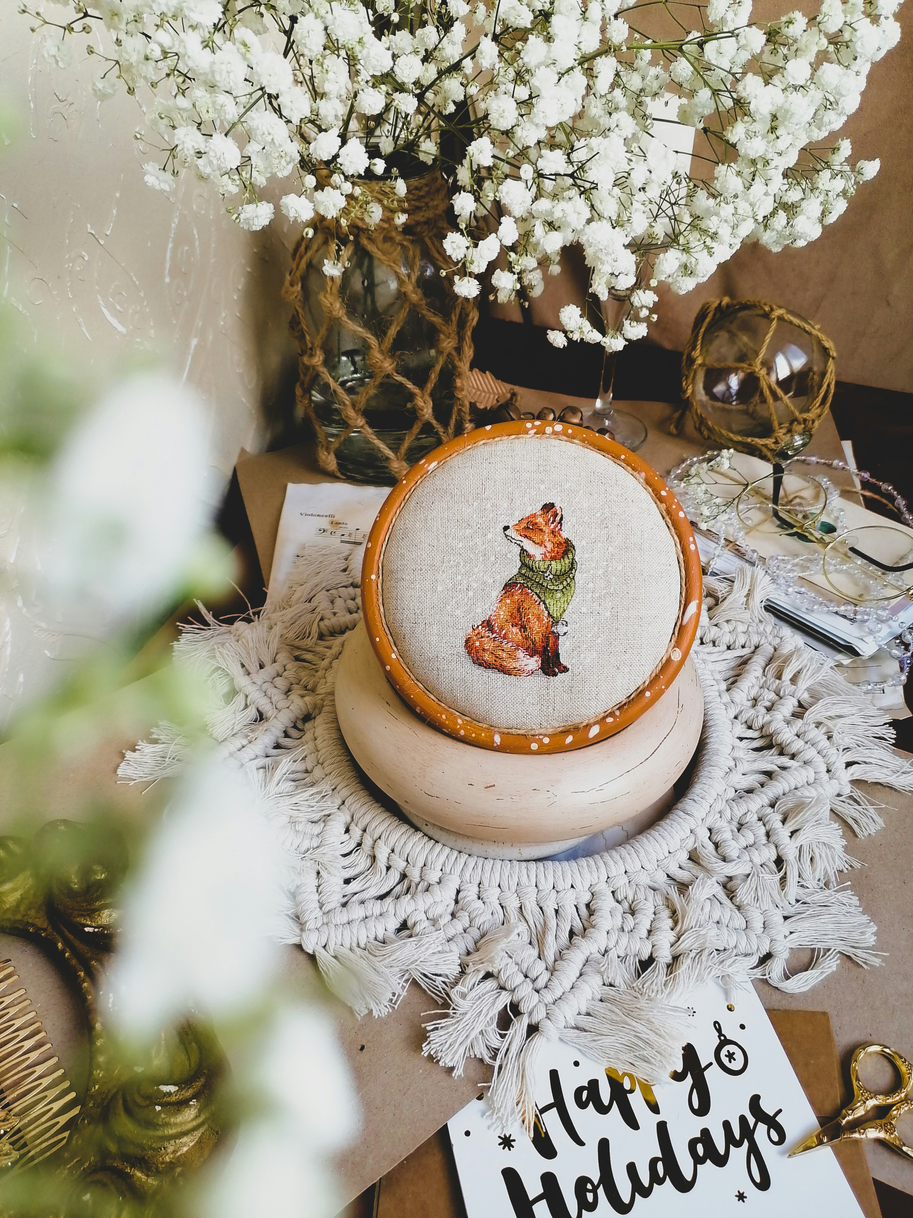 A table topped with a vase filled with white flowers