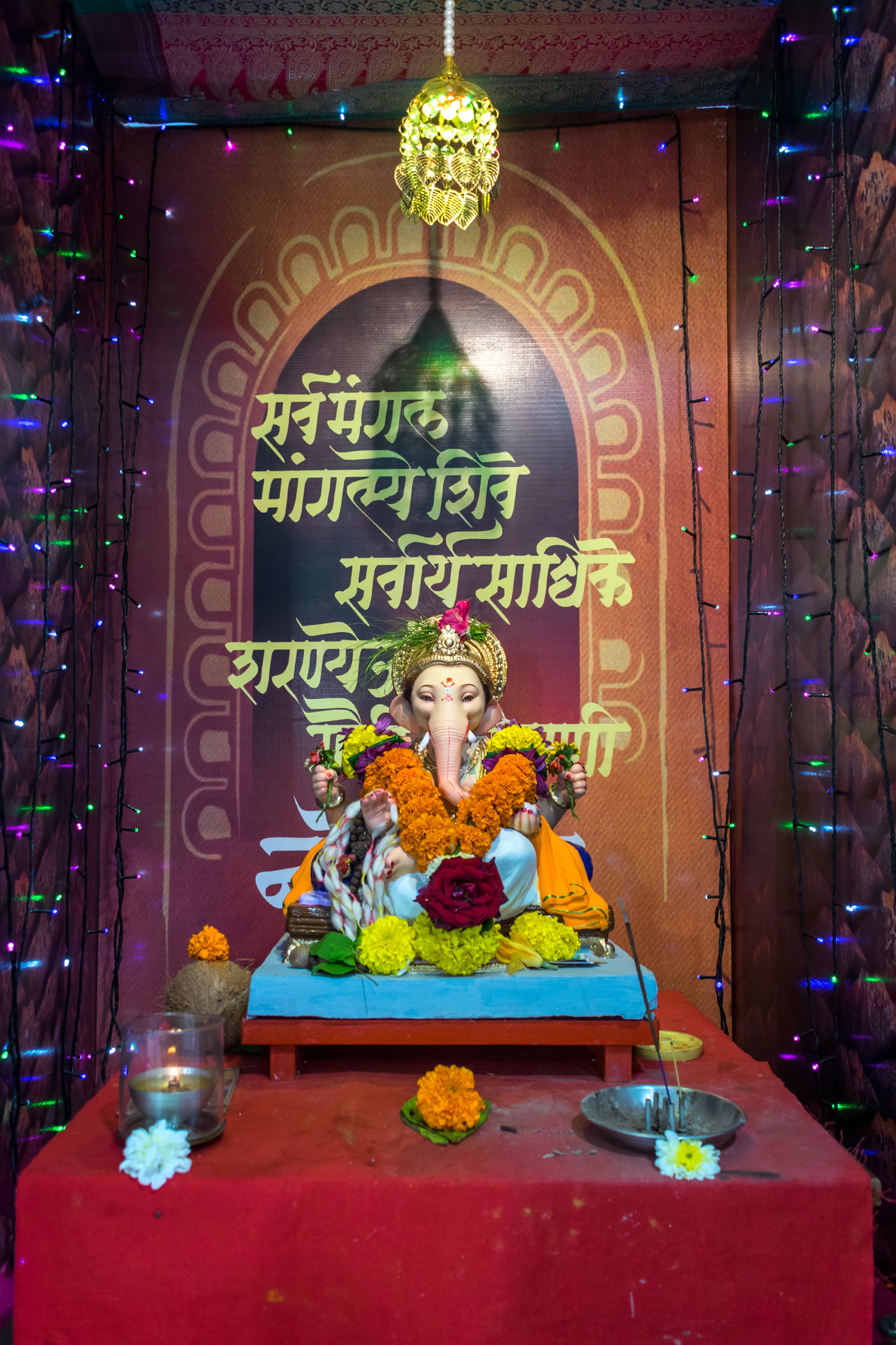 A shrine niche with a statue and offerings