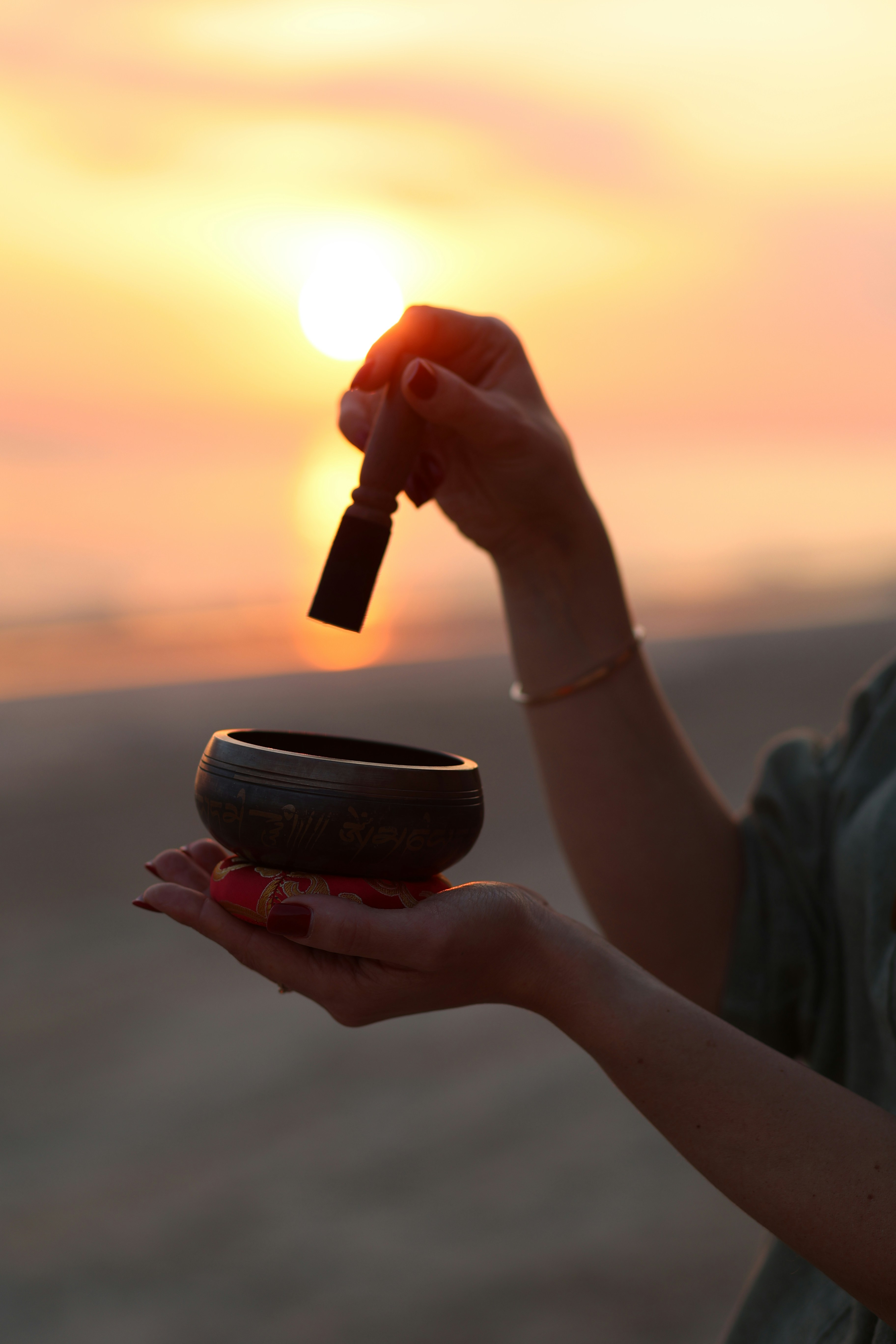 A woman holding a small bowl with a key in it