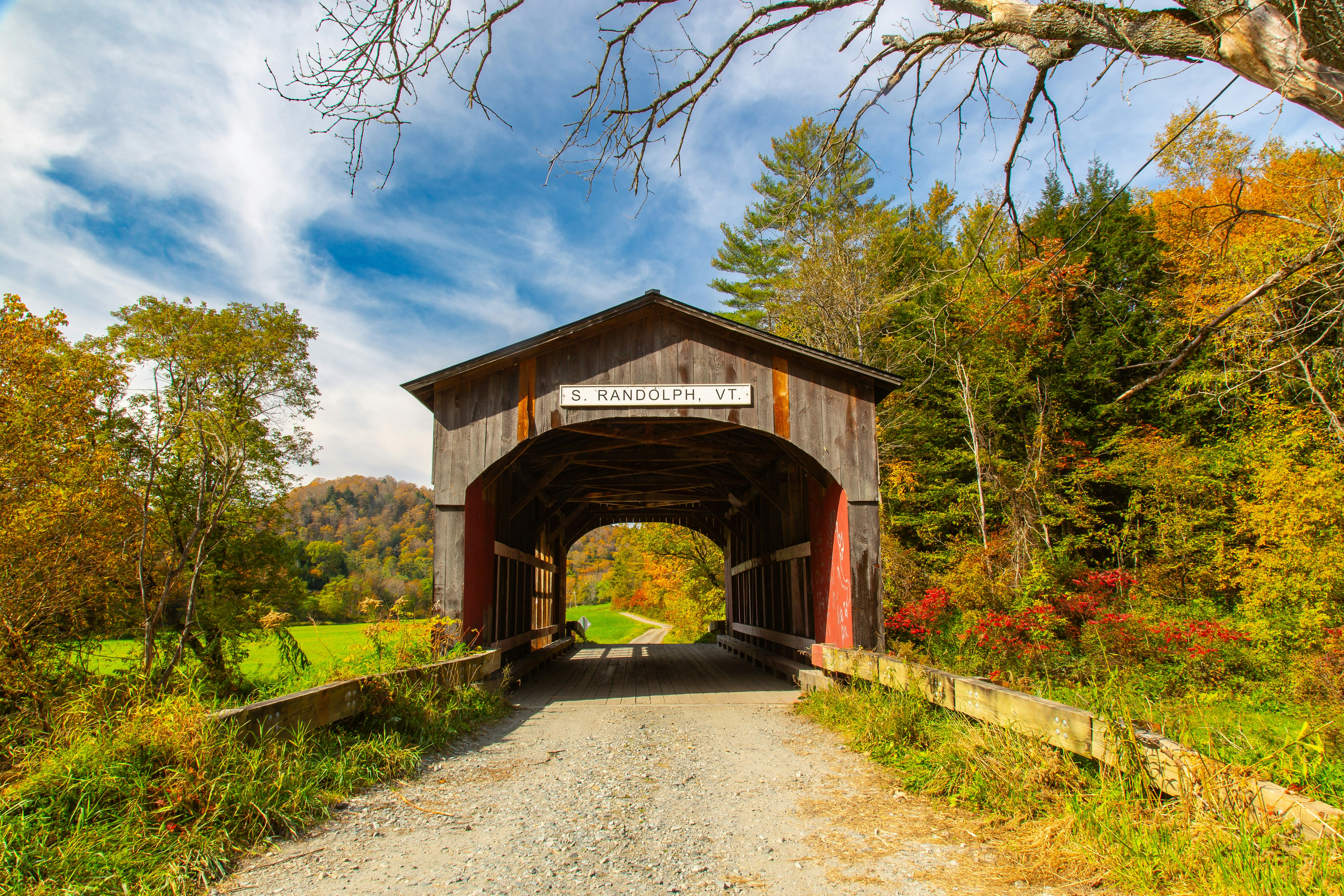 A covered bridge in the middle of a wooded area