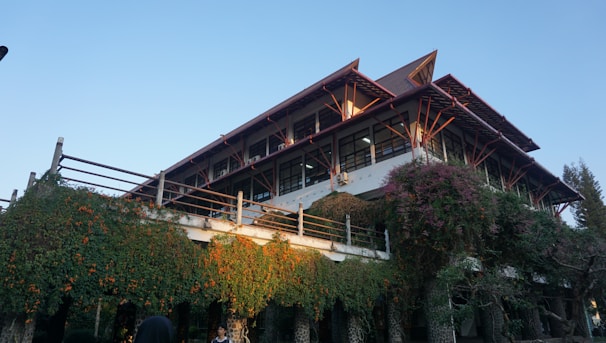 A large building with a lot of trees around it