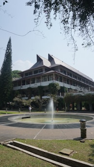 A large building with a fountain in front of it