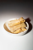 A white bowl filled with food on top of a table
