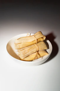 A white bowl filled with food on top of a table