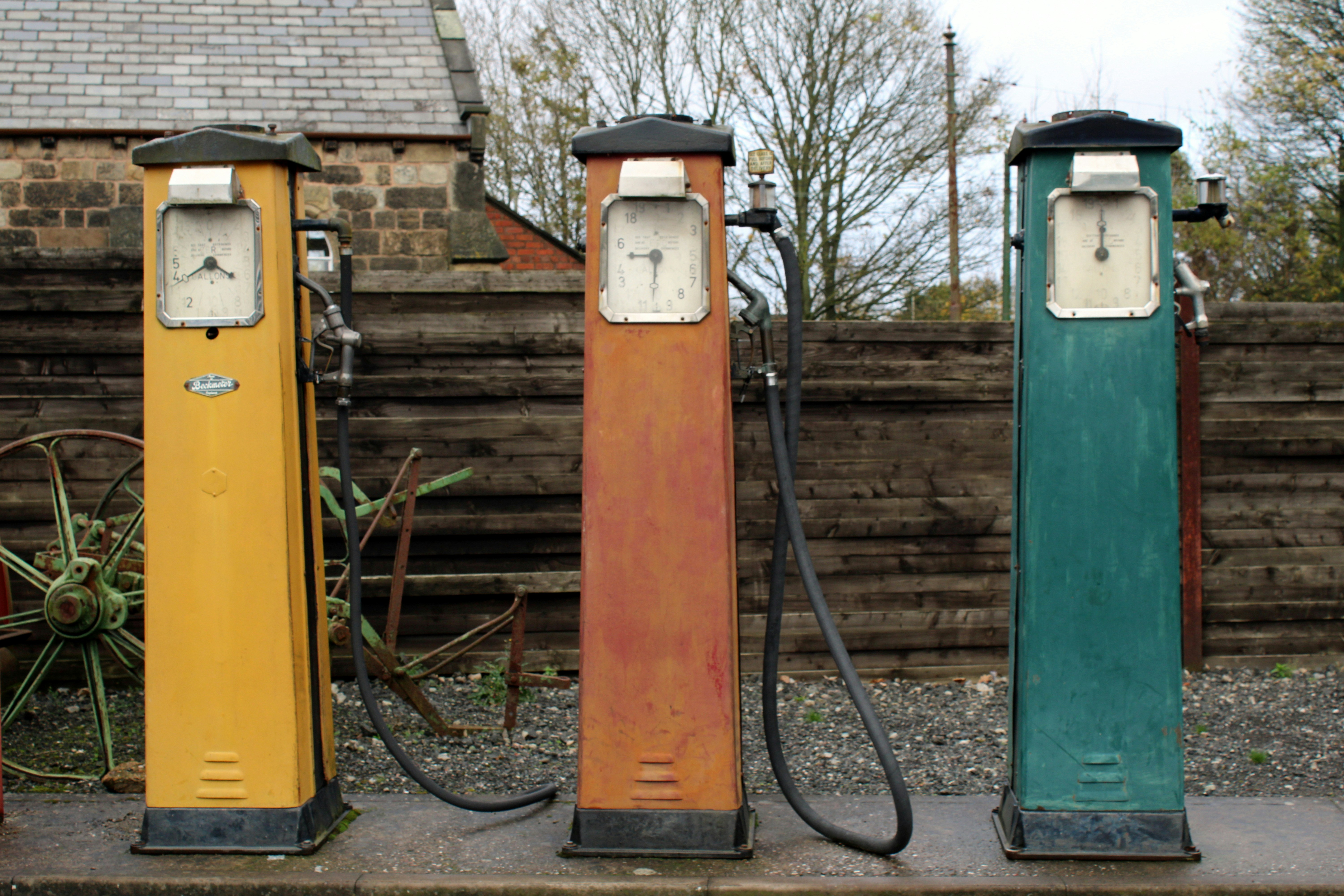 Row of compact electric cars charging at an outdoor lot, representing affordable EV options.
