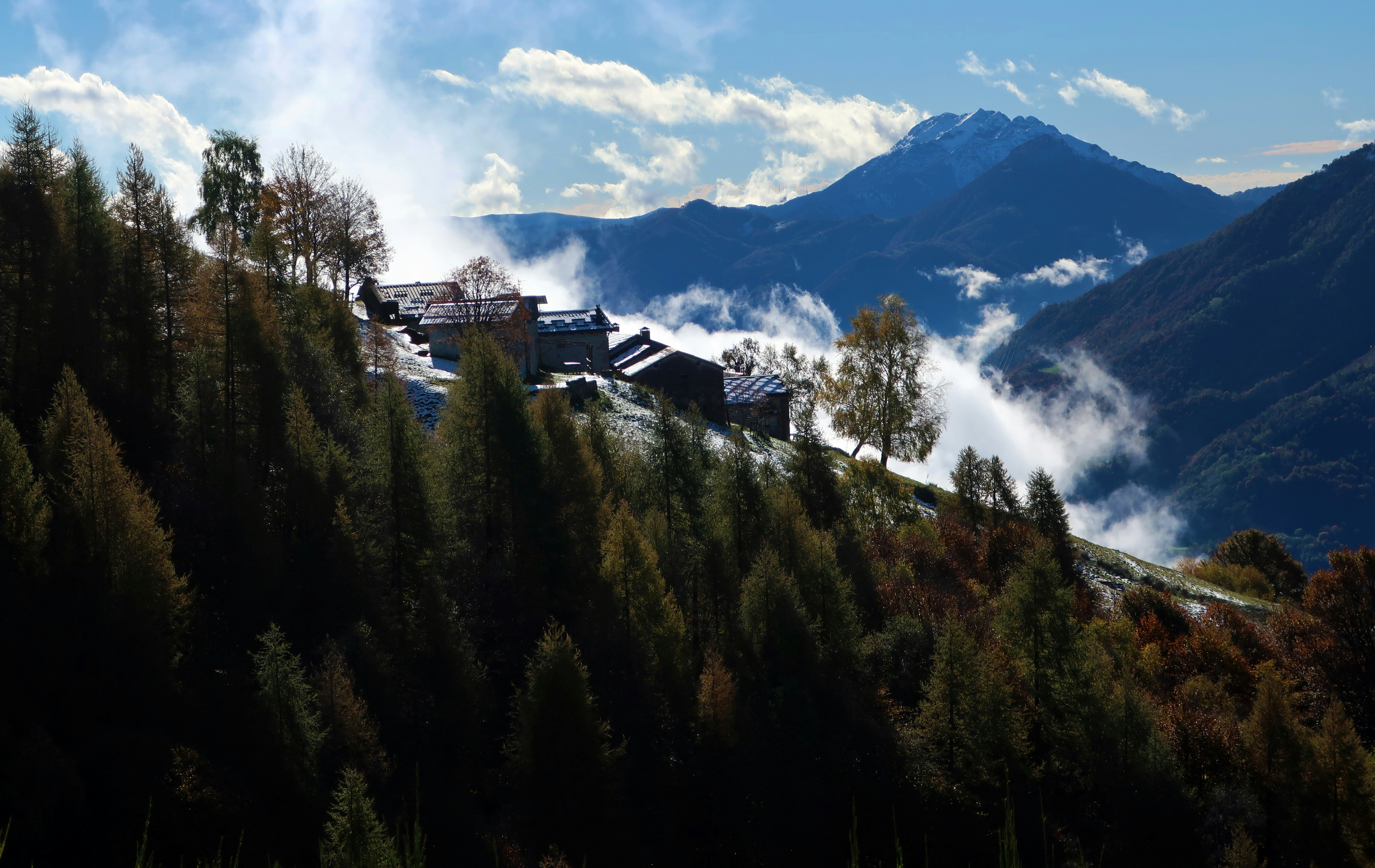 A view of a mountain range with houses in the foreground