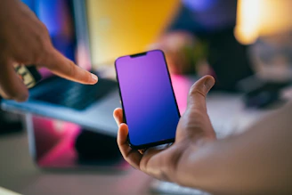 A person holding a cell phone in their hand
