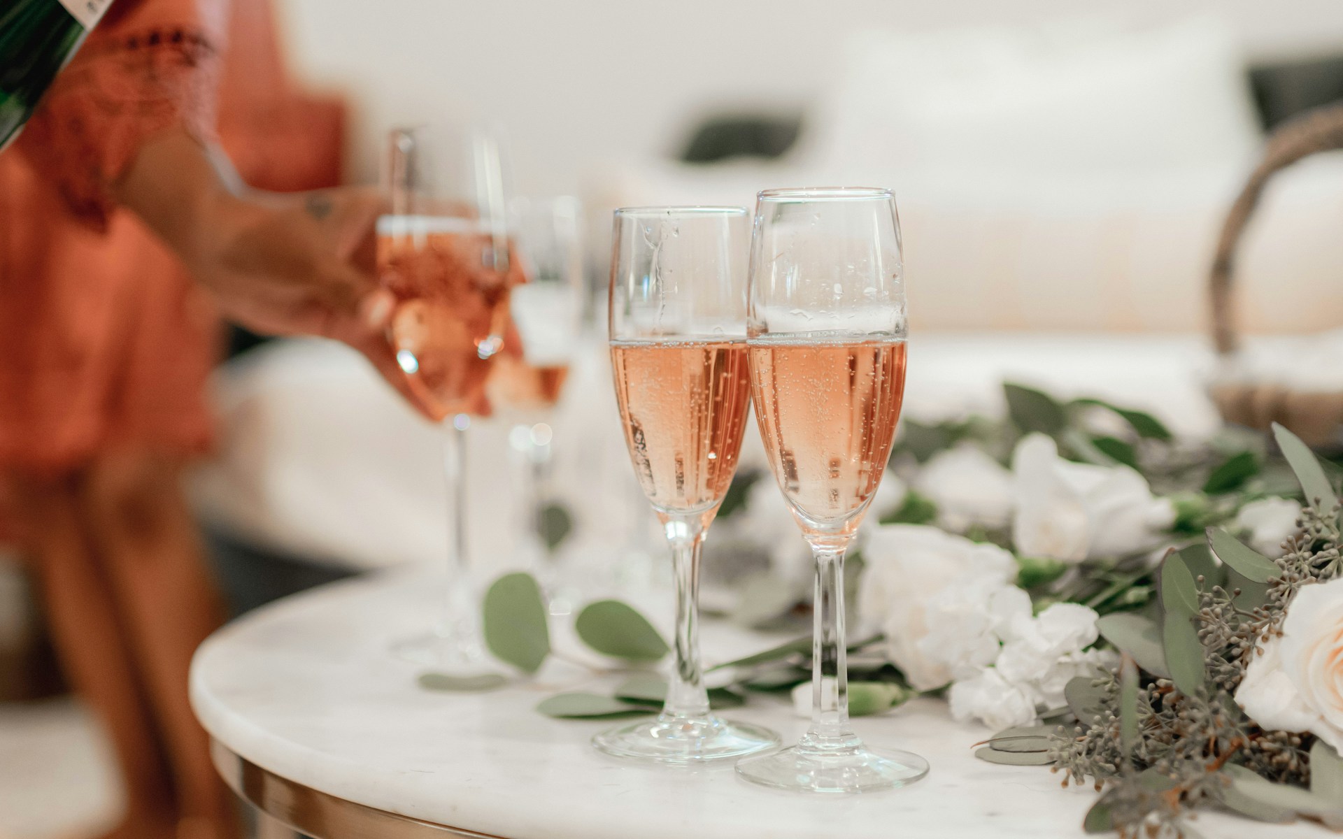 A table topped with lots of glasses of wine