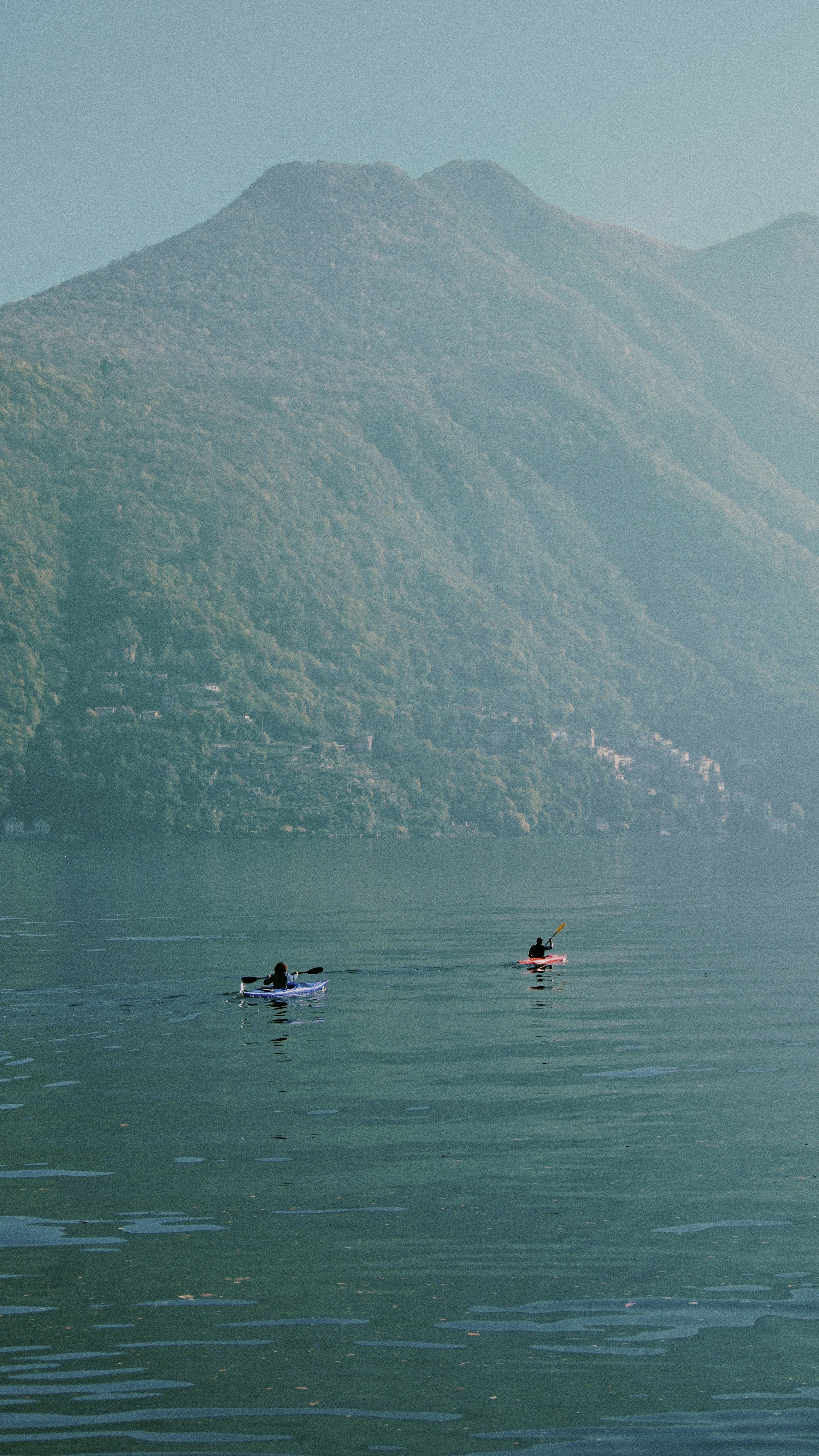A couple of people in a boat on a lake