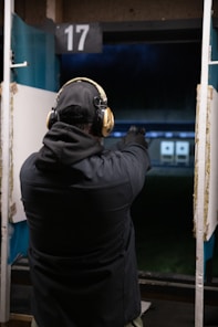 A man in a black jacket is playing a game