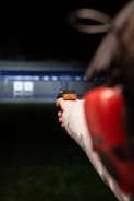 A person holding a red and black object in their hand
