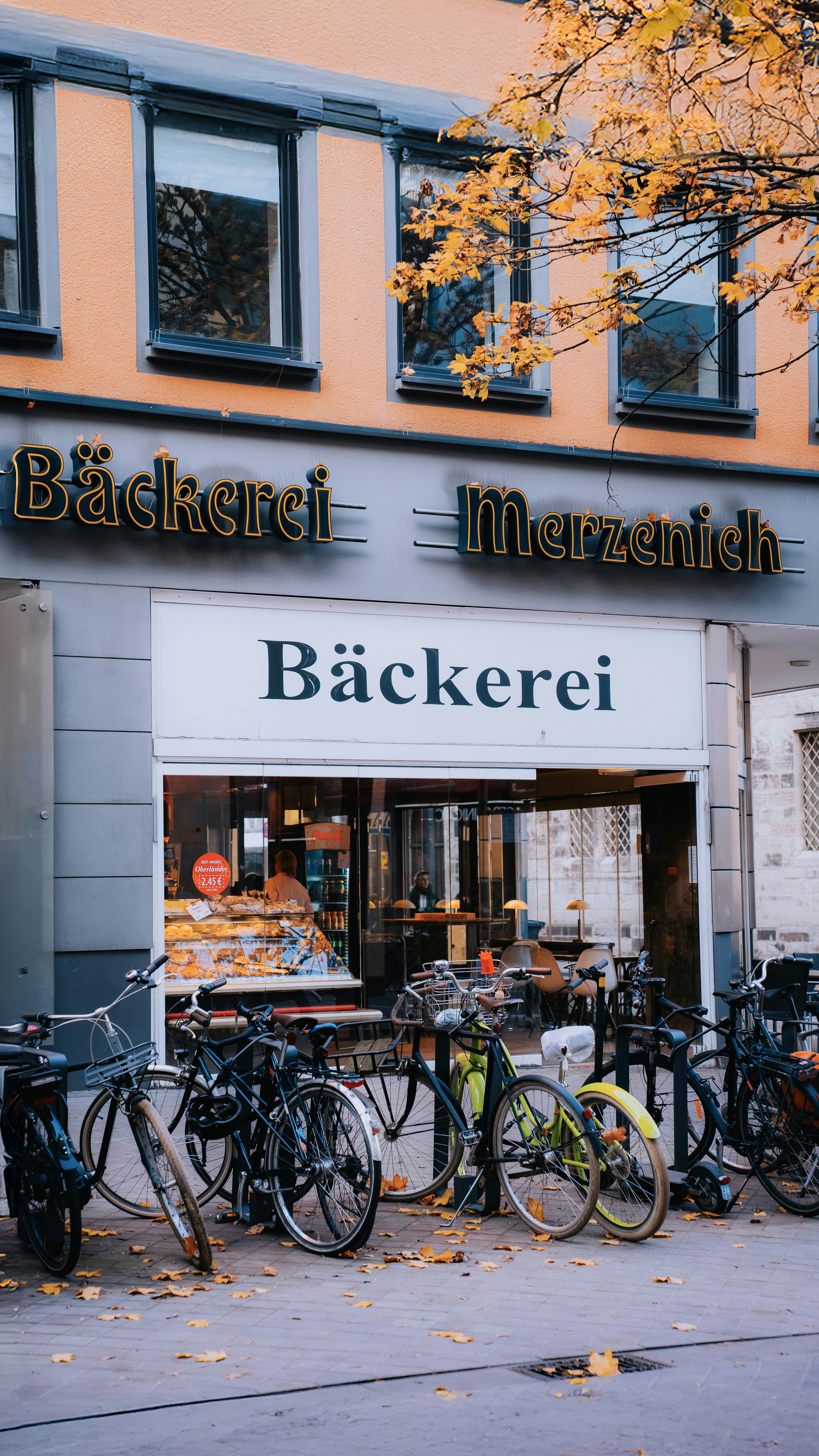 A bunch of bikes are parked outside of a store