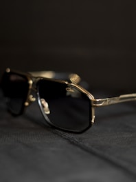 A pair of sunglasses sitting on top of a bed