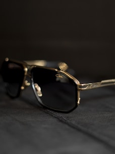 A pair of sunglasses sitting on top of a bed