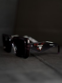 A pair of sunglasses sitting on the ground