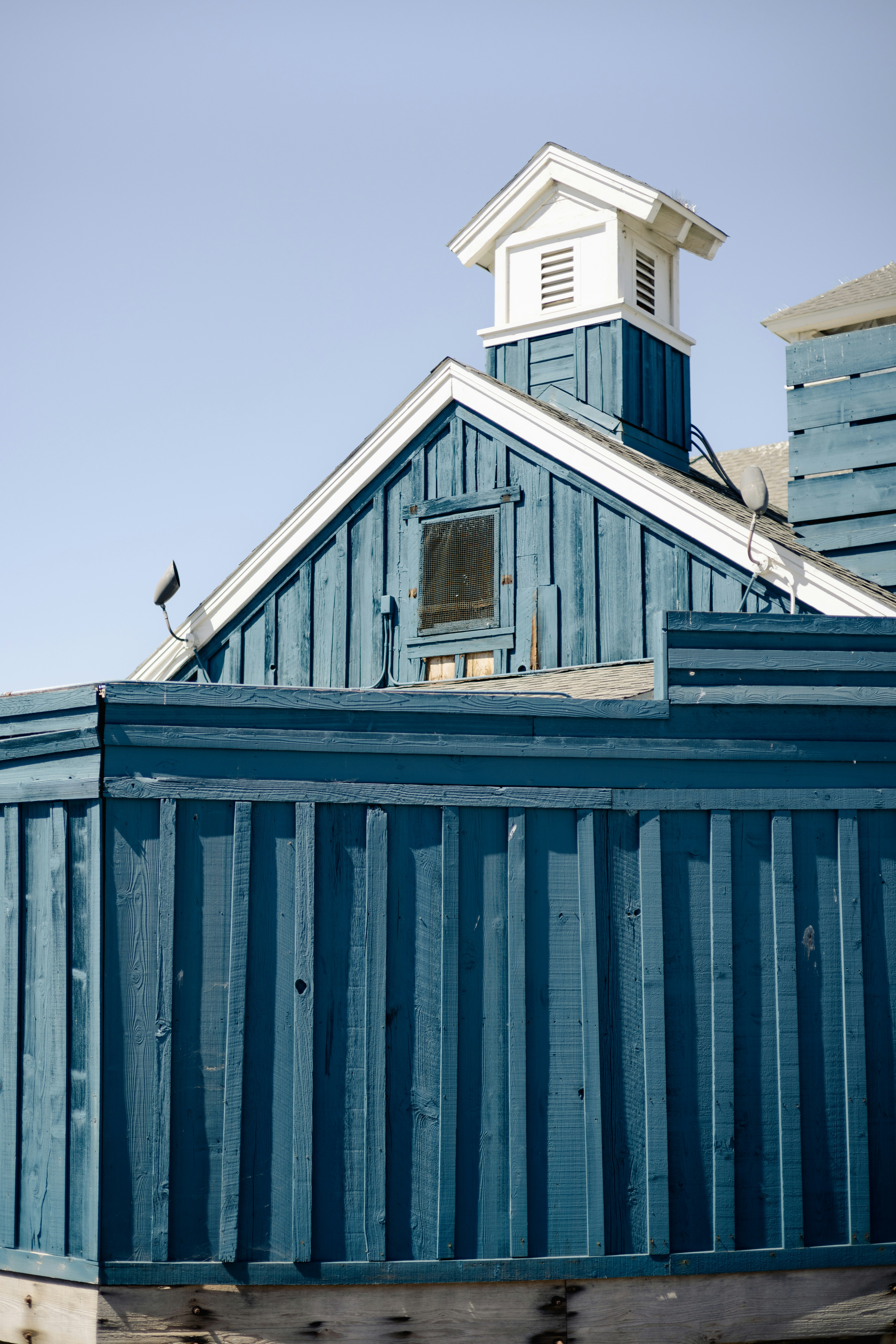 A blue building with a clock tower on top of it
