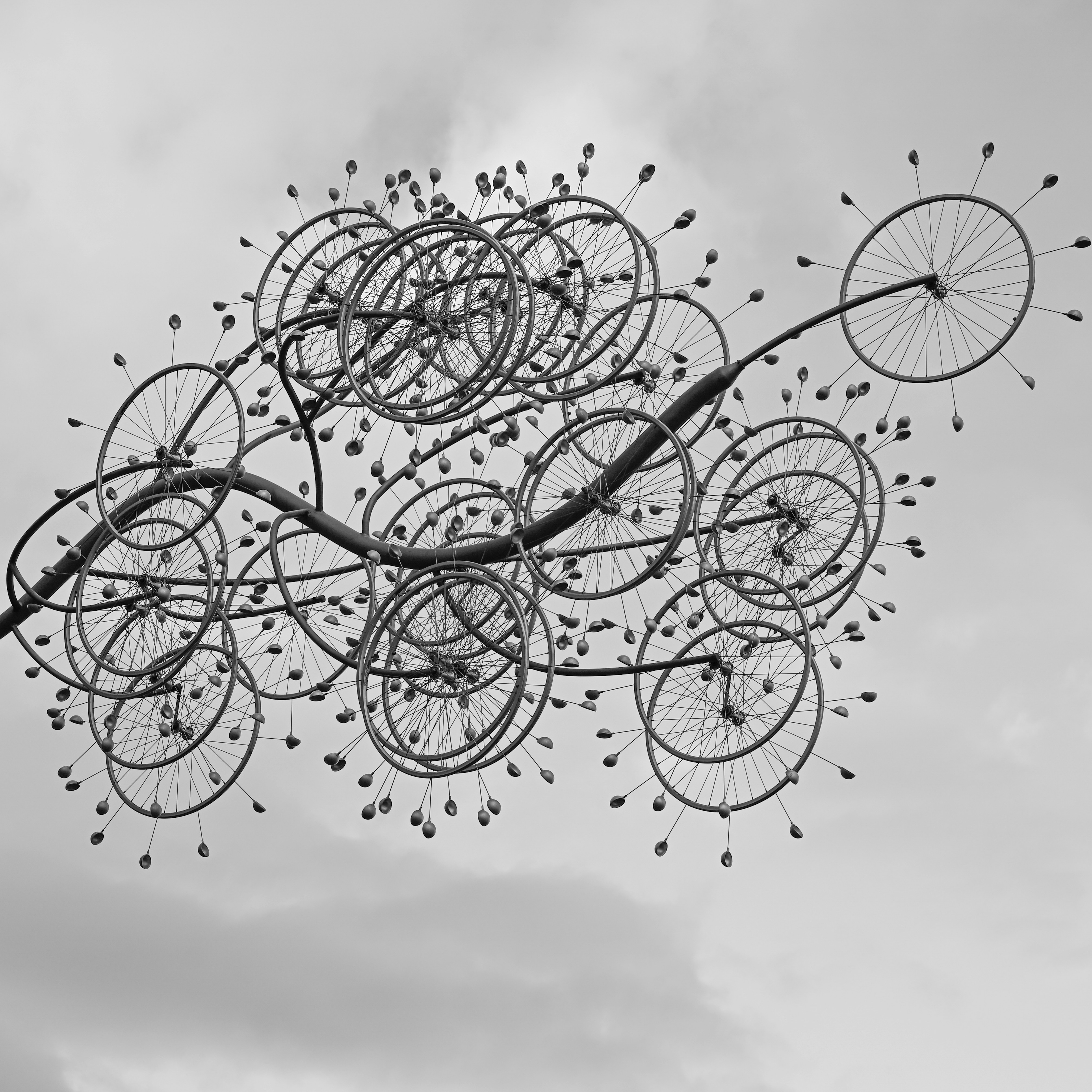 A black and white photo of a kite flying in the sky
