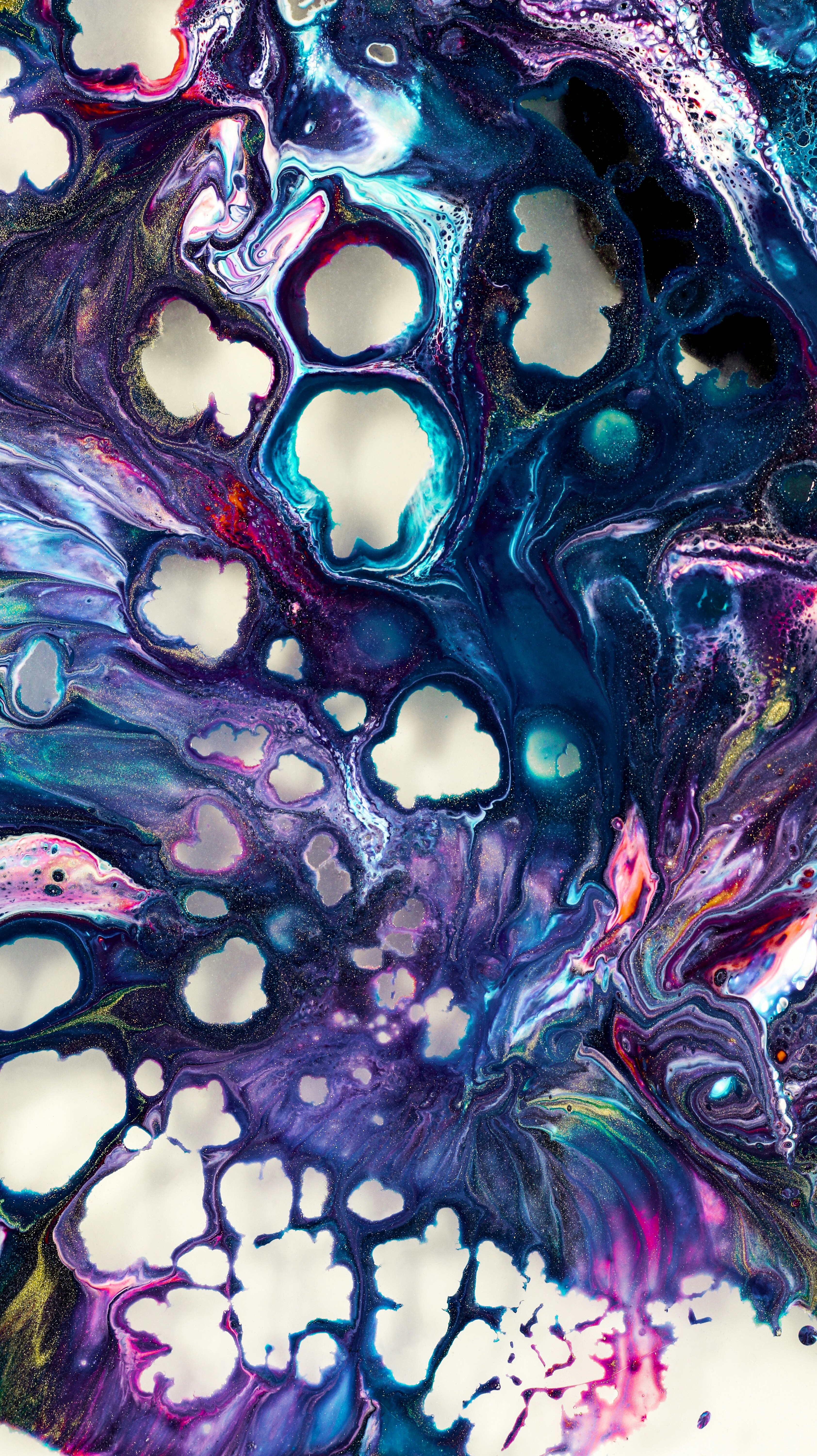 A close up of an abstract painting on a white surface