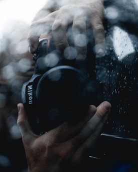 A person holding a camera in front of a mirror