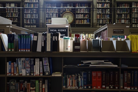 A library filled with lots of books and a clock