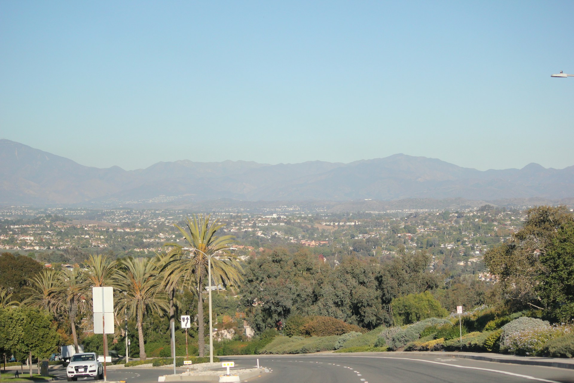 A view of a street with mountains in the background