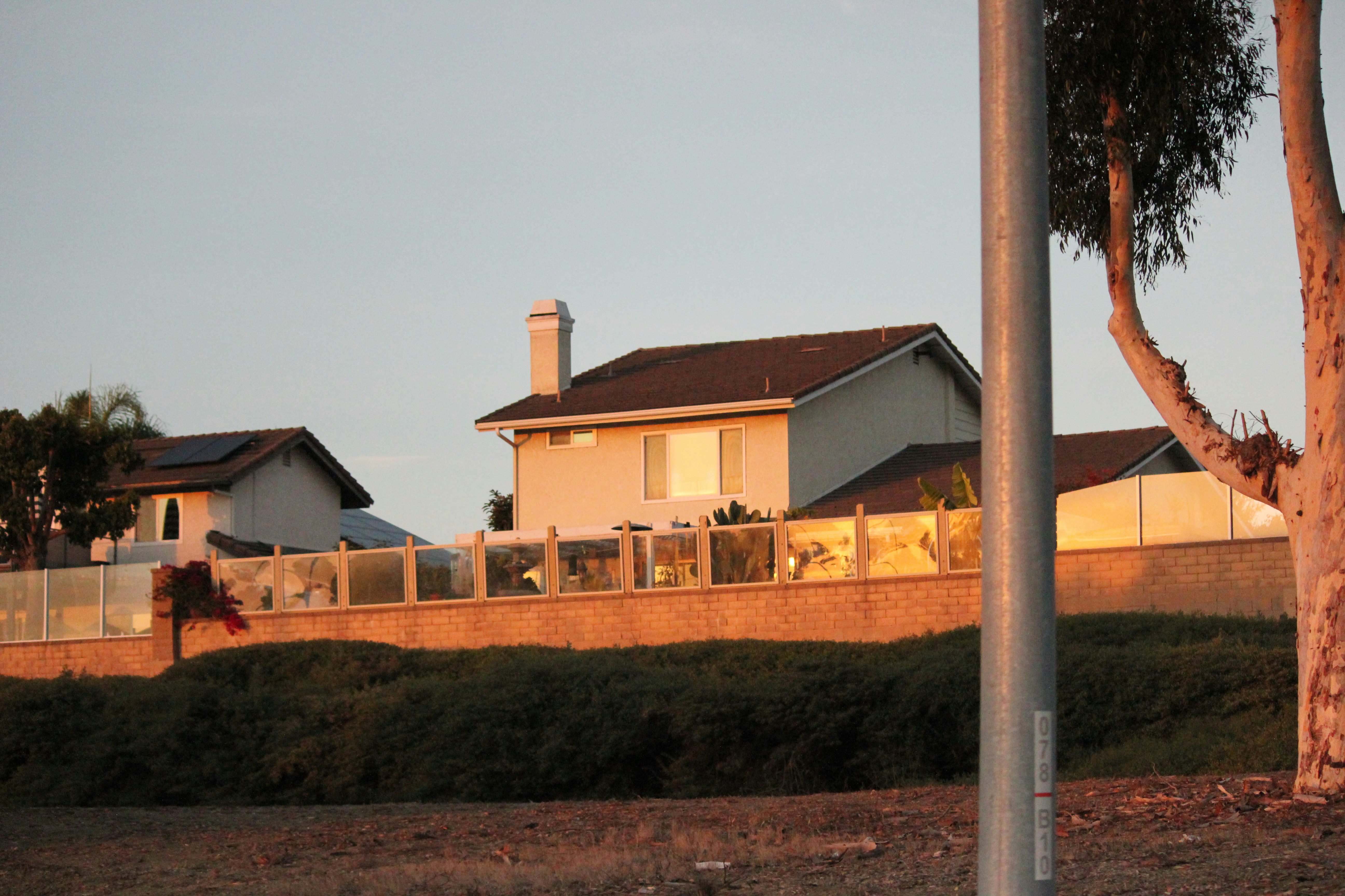 A street sign in front of a house