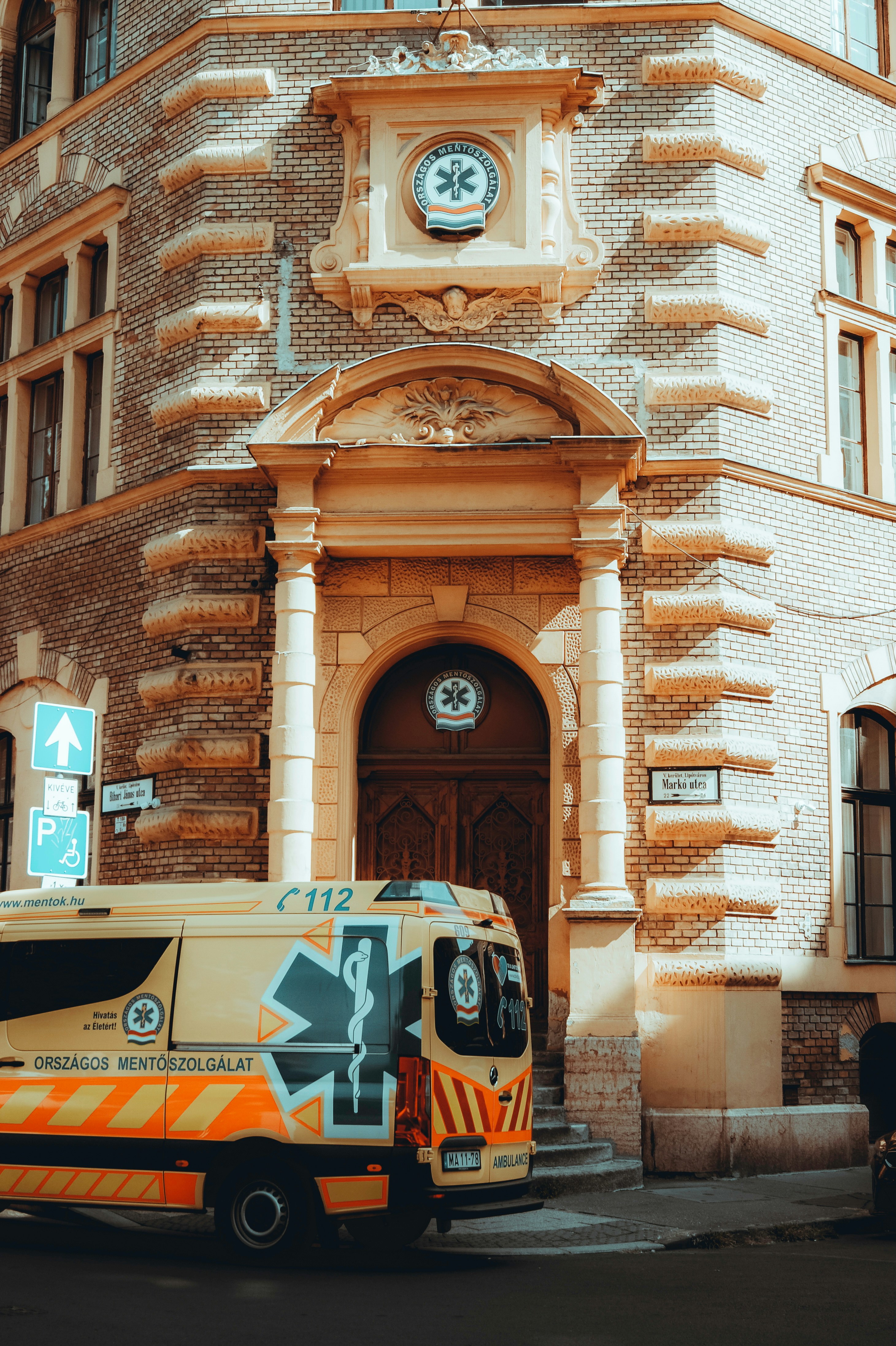 A van parked in front of a large building