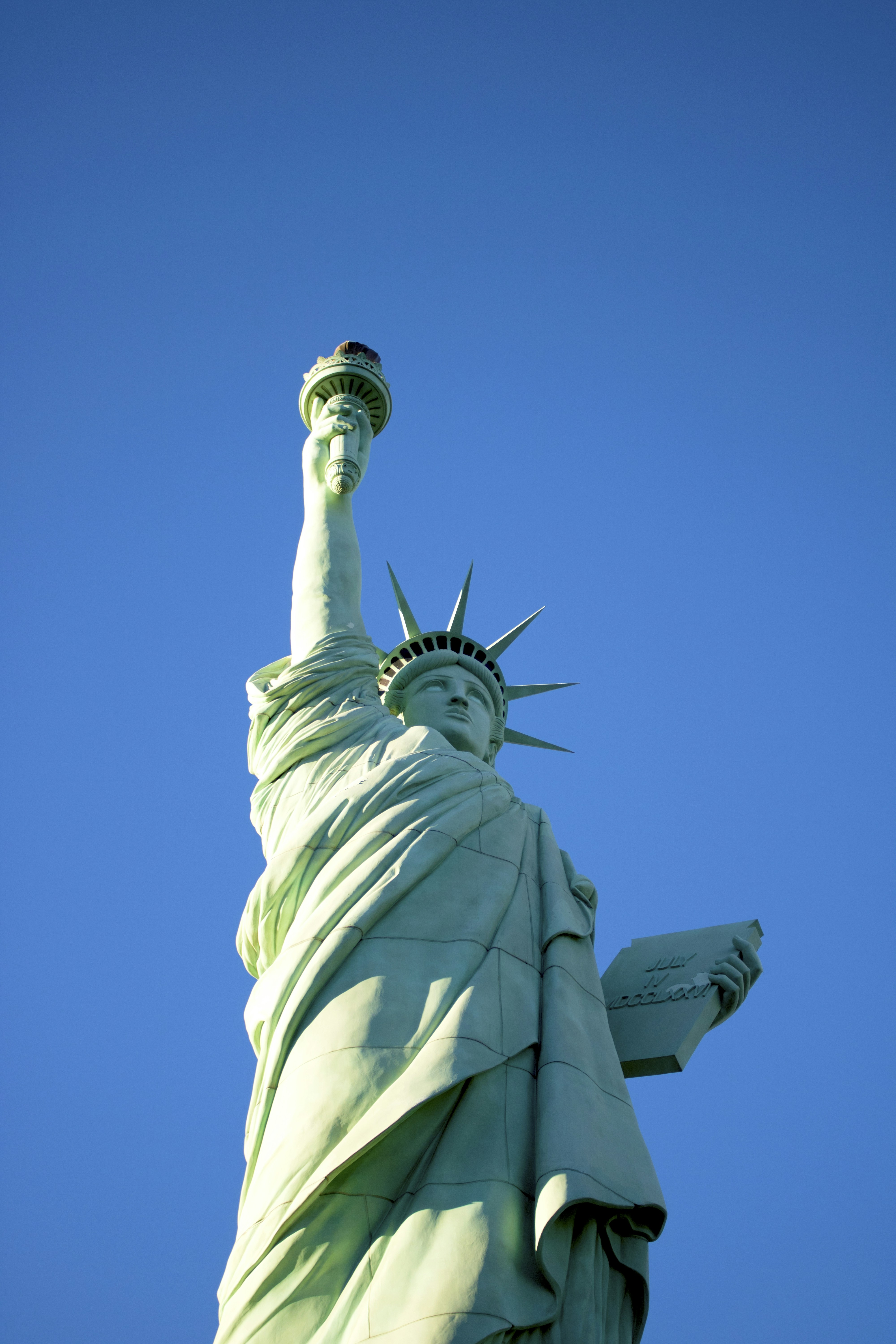 The statue of liberty against a blue sky