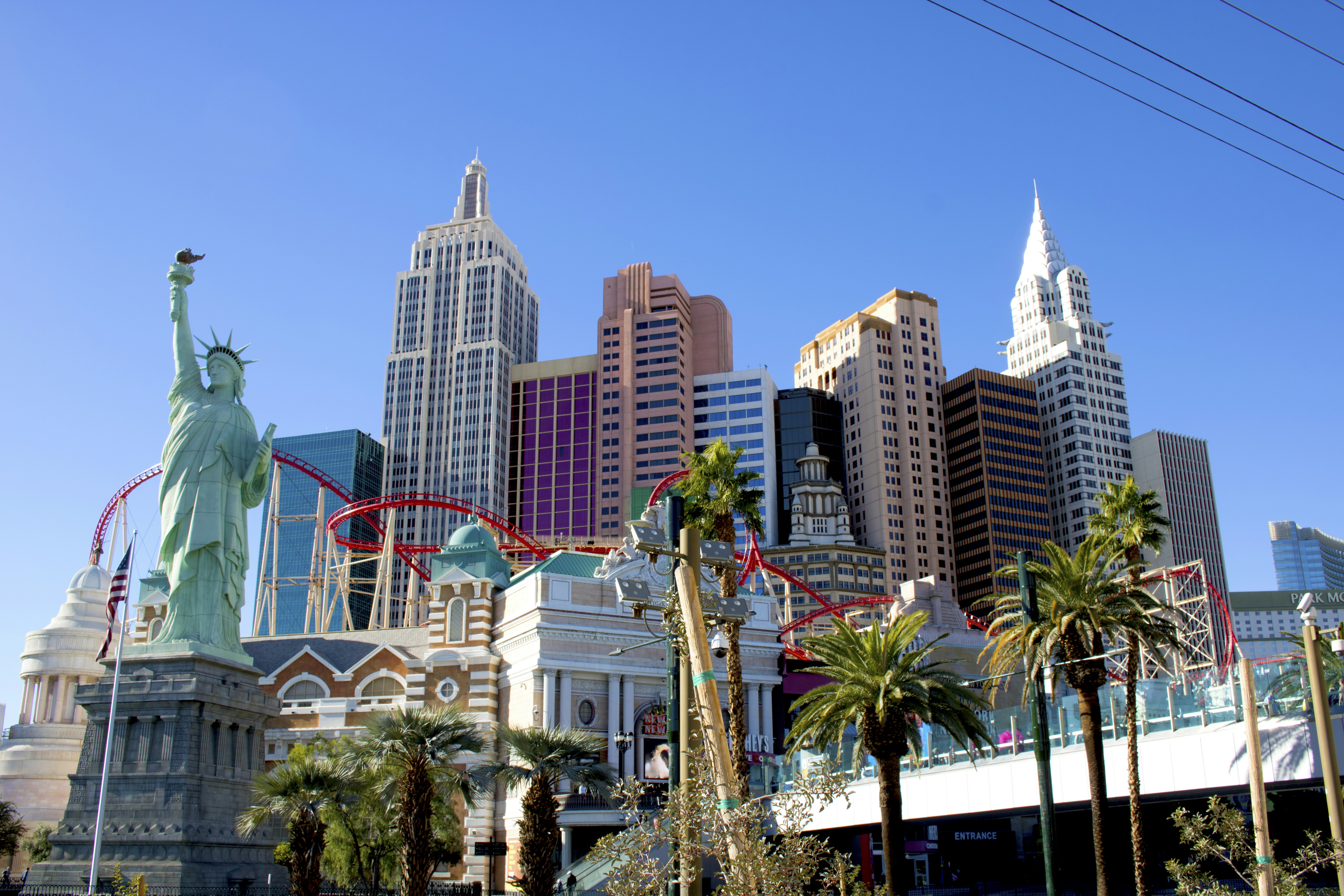 The statue of liberty stands in front of the las vegas skyline