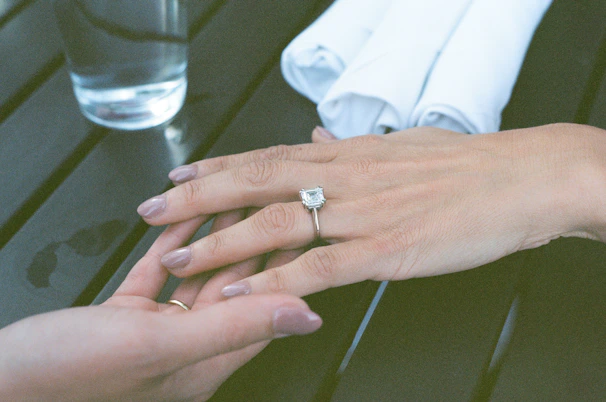 A man and a woman holding hands over a table