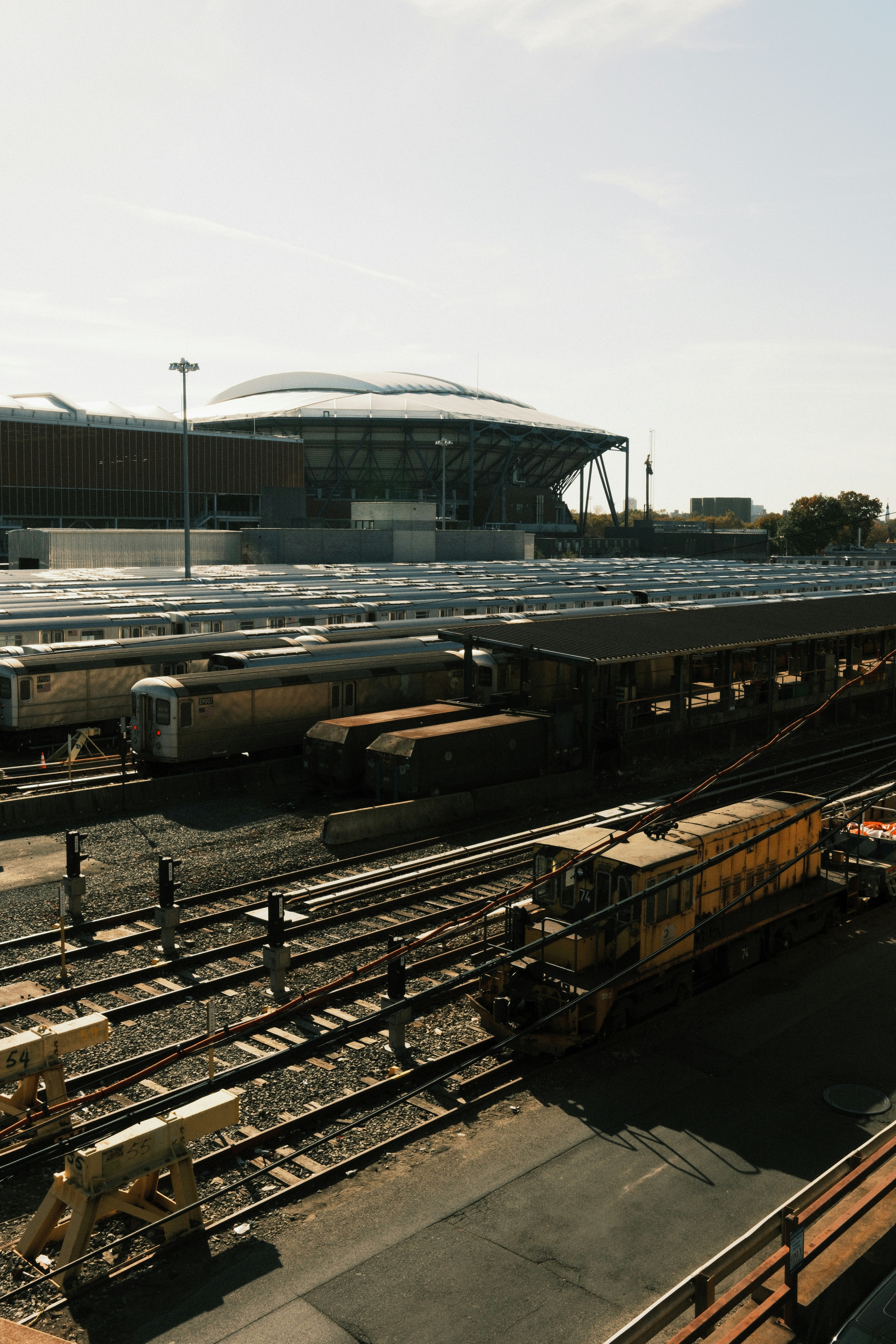 A train yard with several trains on the tracks