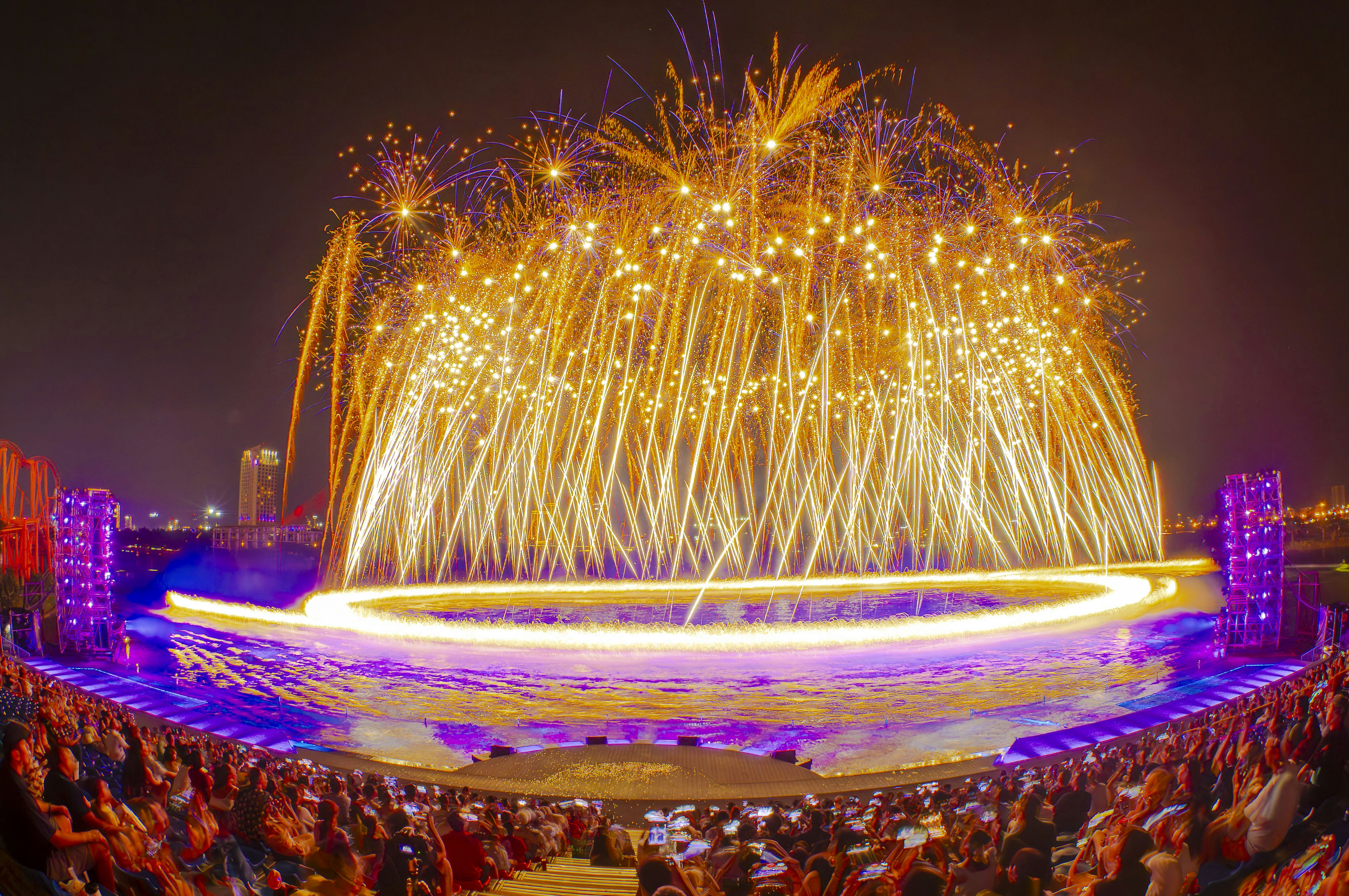 A large crowd of people watching a fireworks show