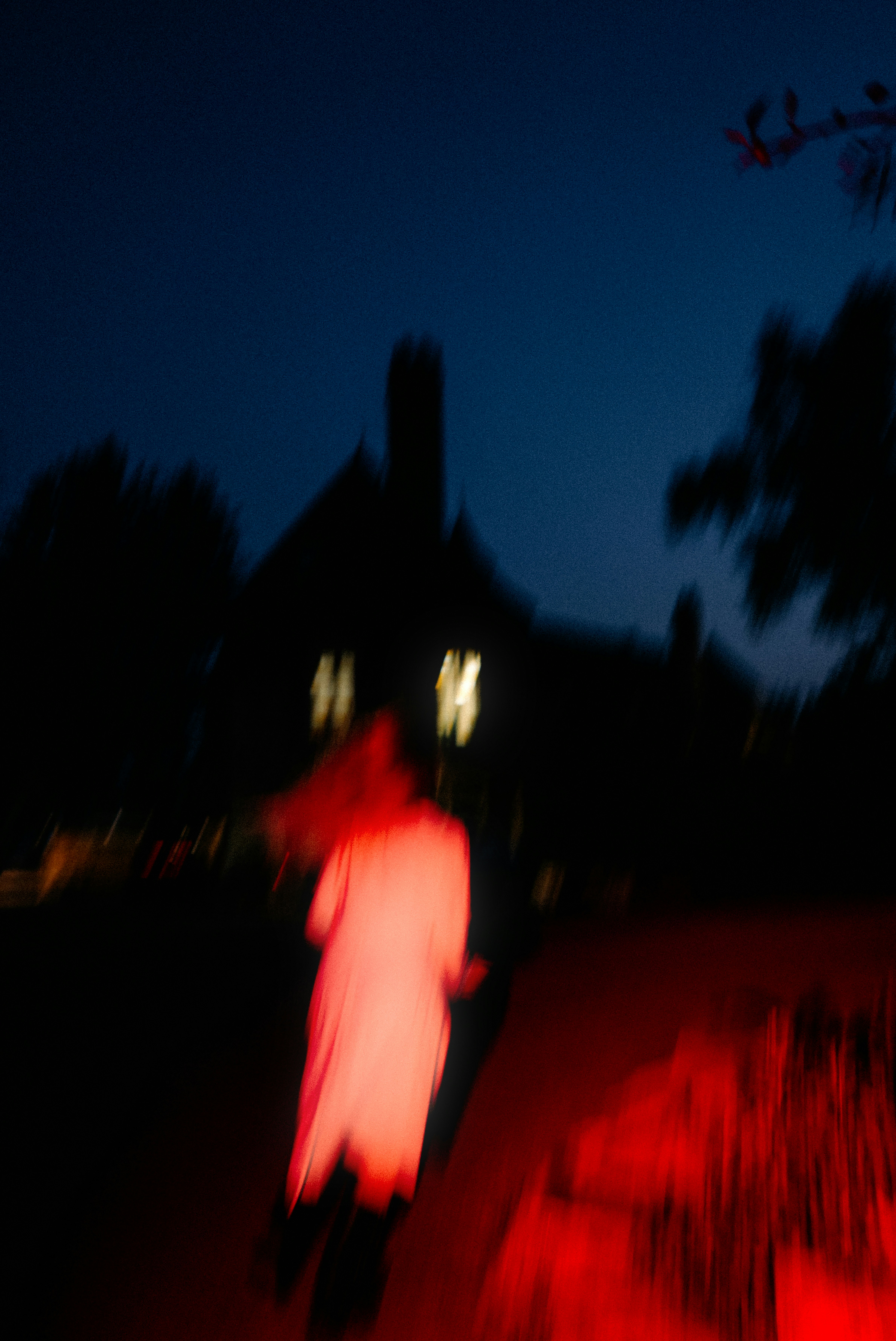 A blurry photo of a person walking in the dark
