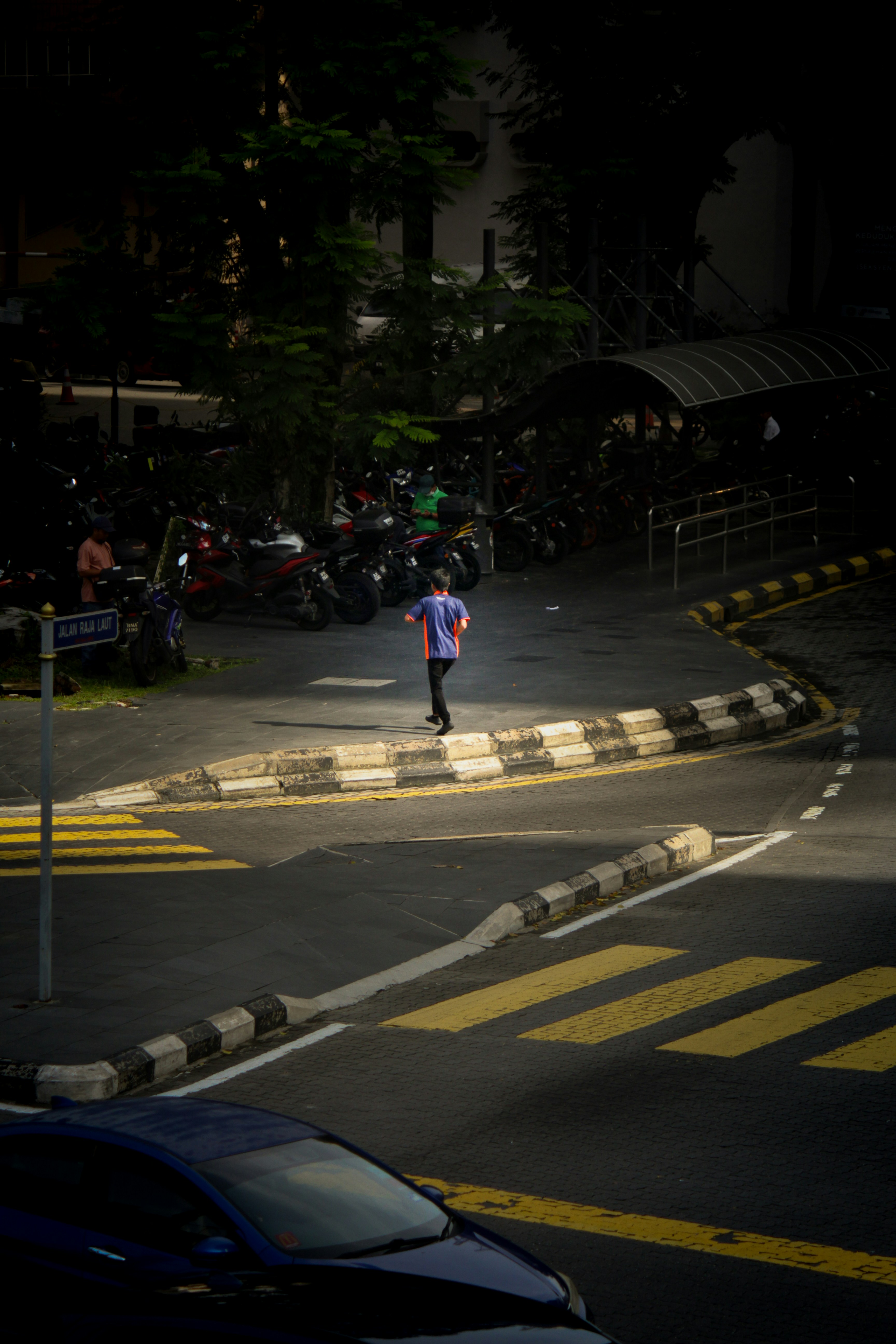 A person walking across a street at night