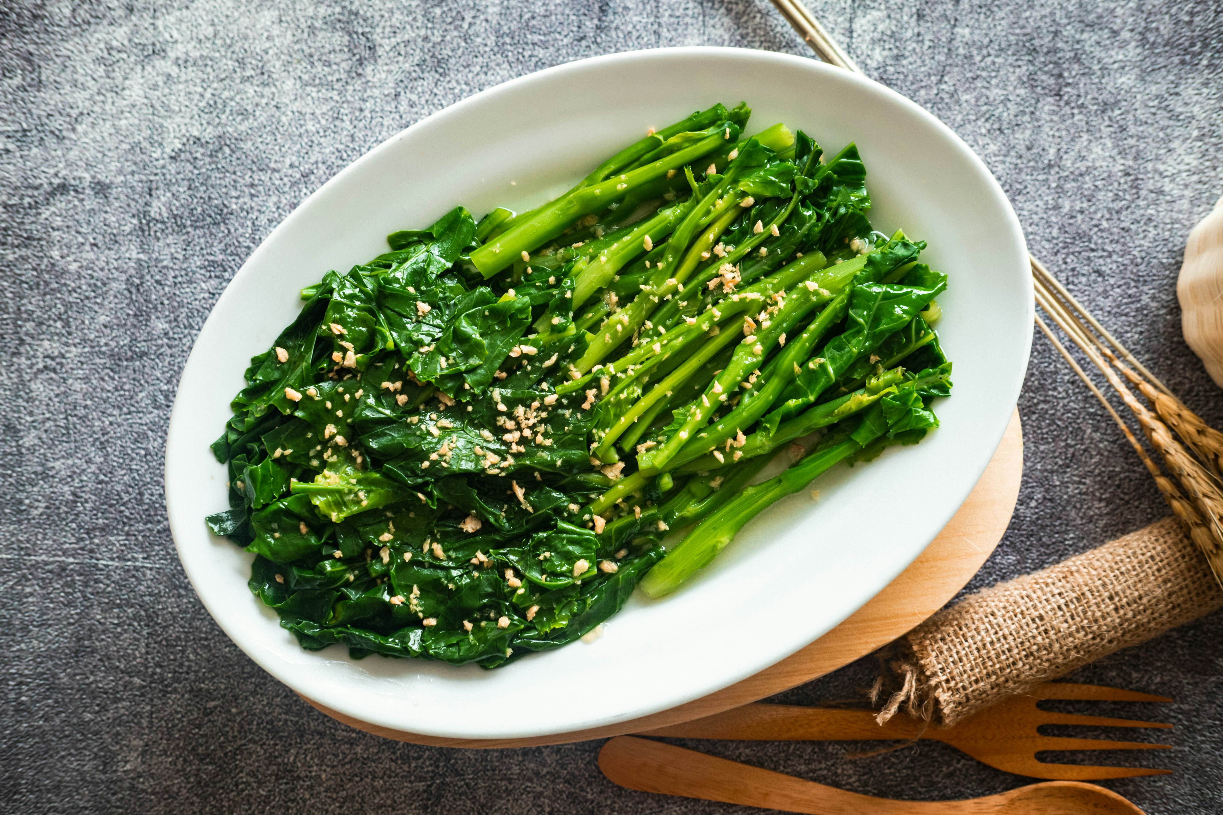 A plate of broccoli with sesame seeds on it
