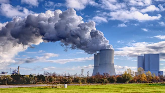 A factory with smoke pouring out of it's stacks