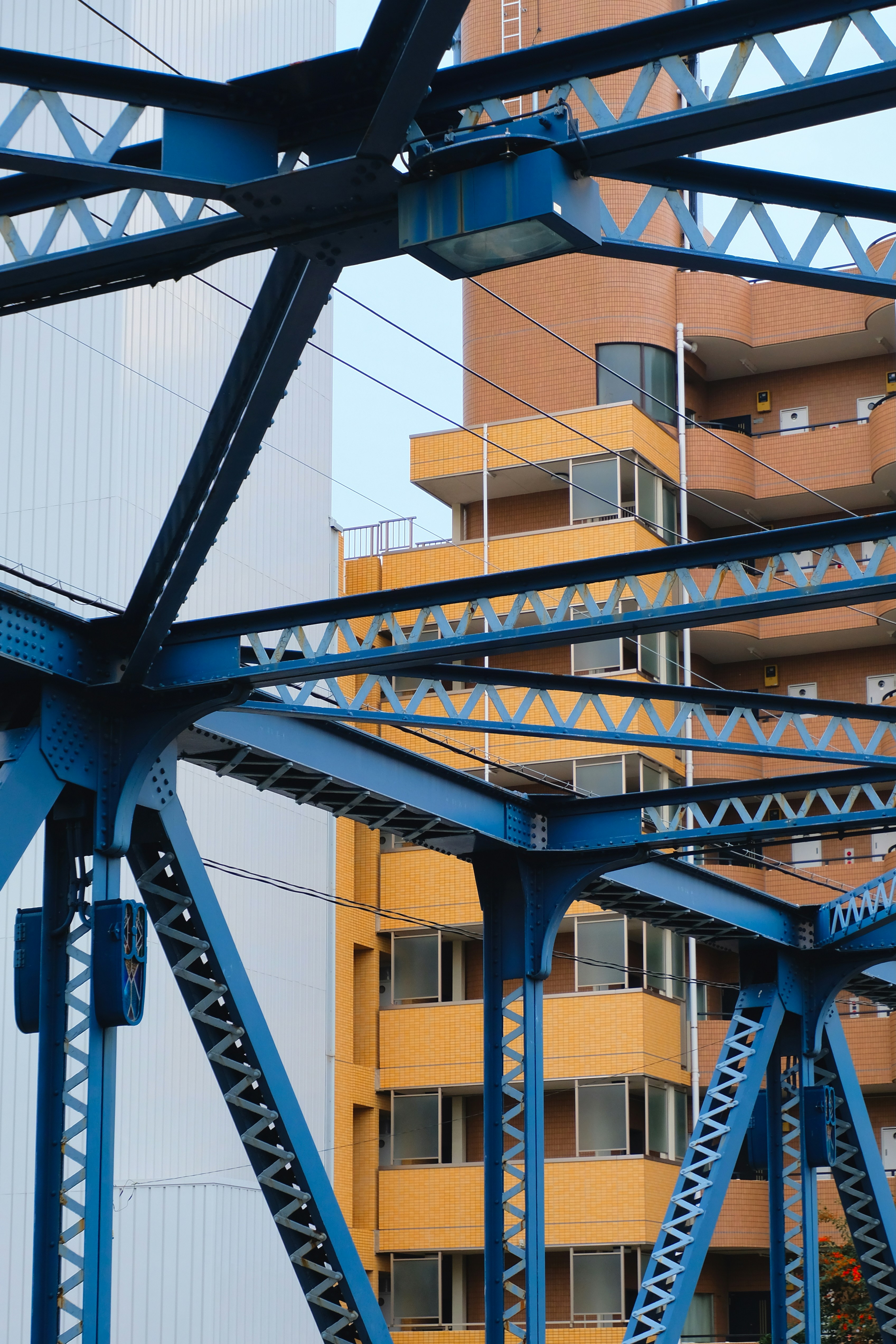 A blue metal structure with a building in the background