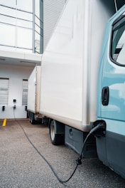 A blue truck parked in front of a building