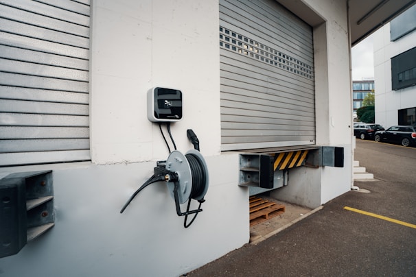 A parking meter attached to the side of a building
