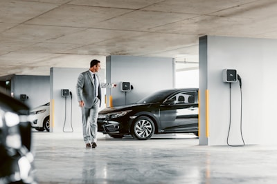 A man in a suit walking towards a car