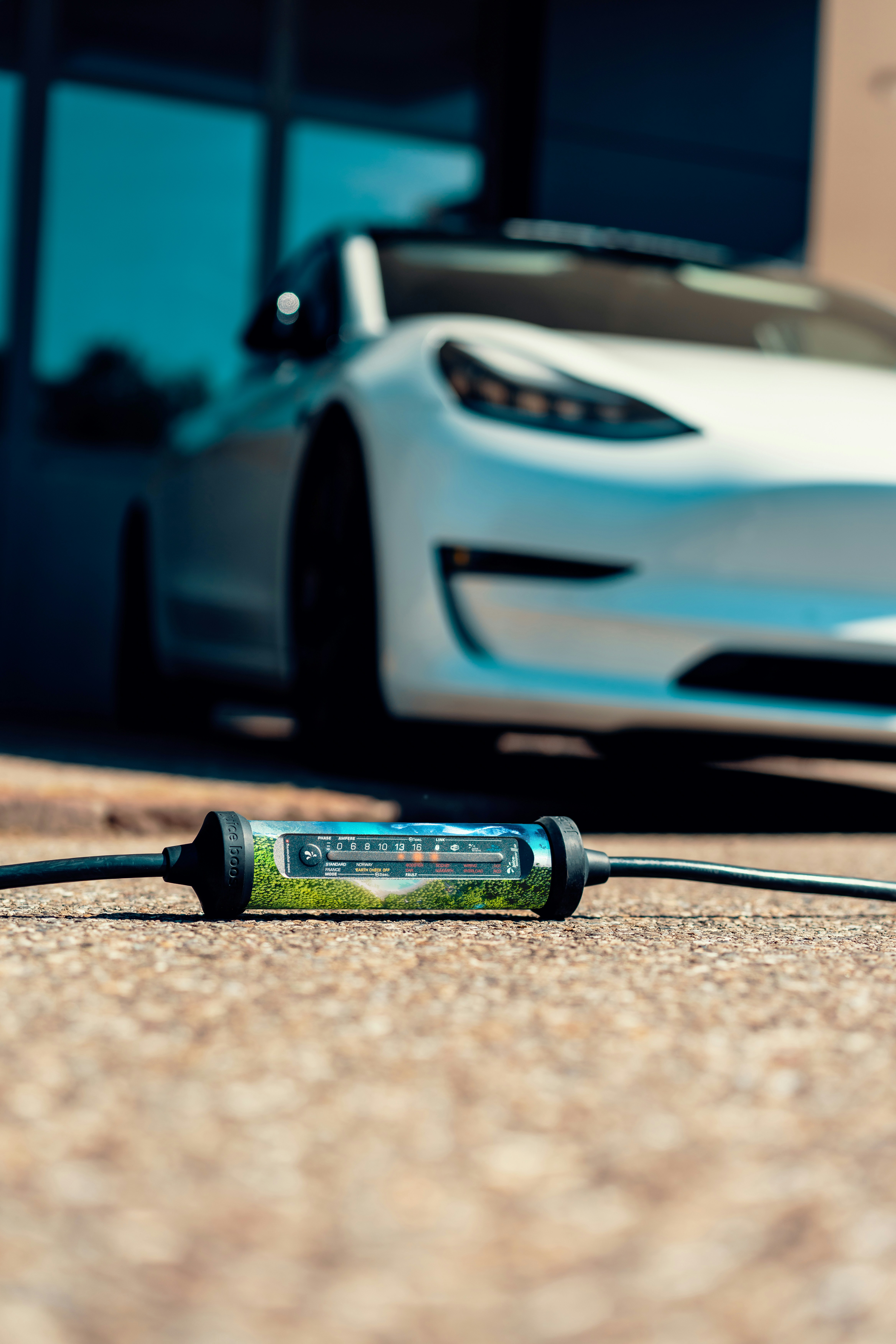 A white sports car parked in front of a building