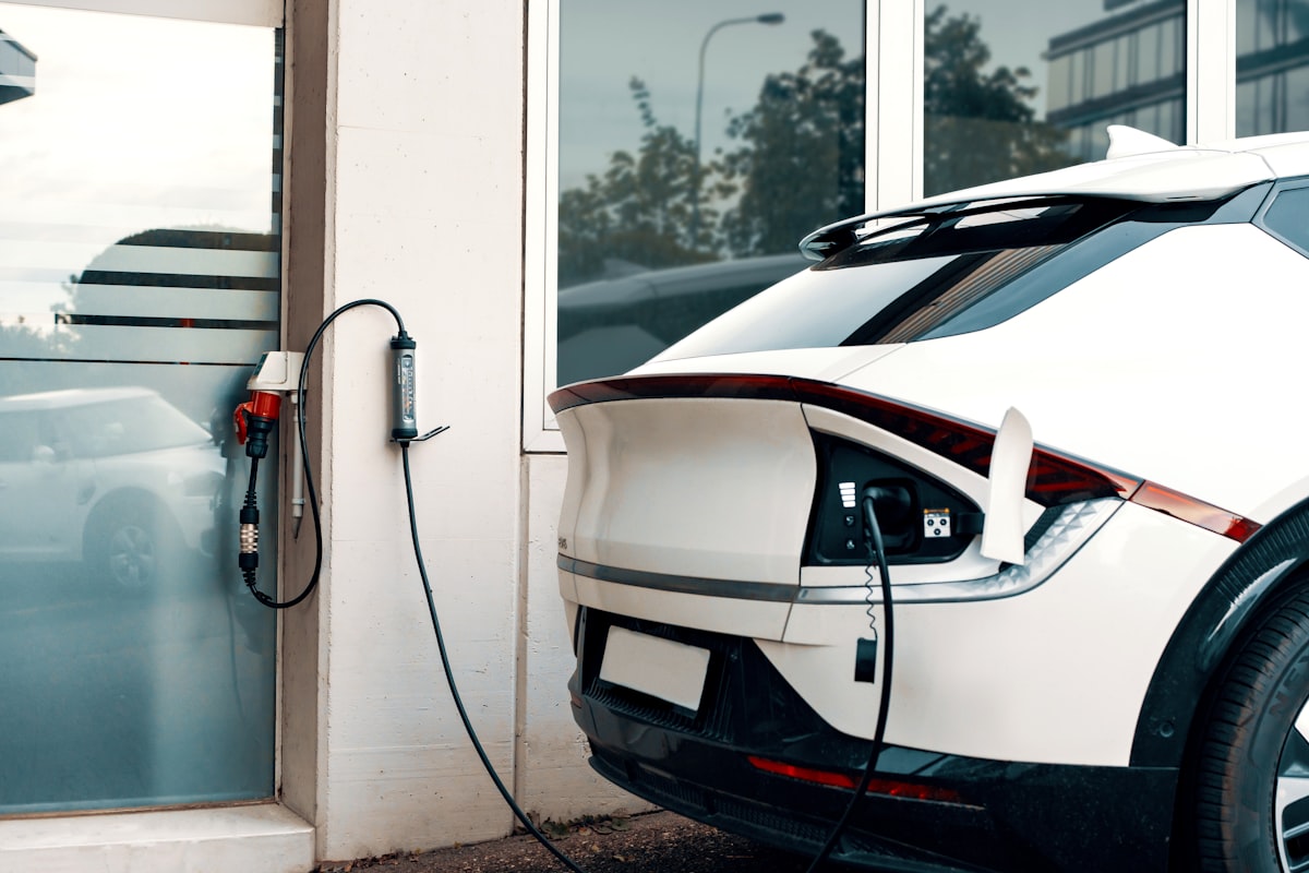 Electric car plugged into a home EV charging station — Tesla Wall Connector vs ChargePoint Home Flex comparison