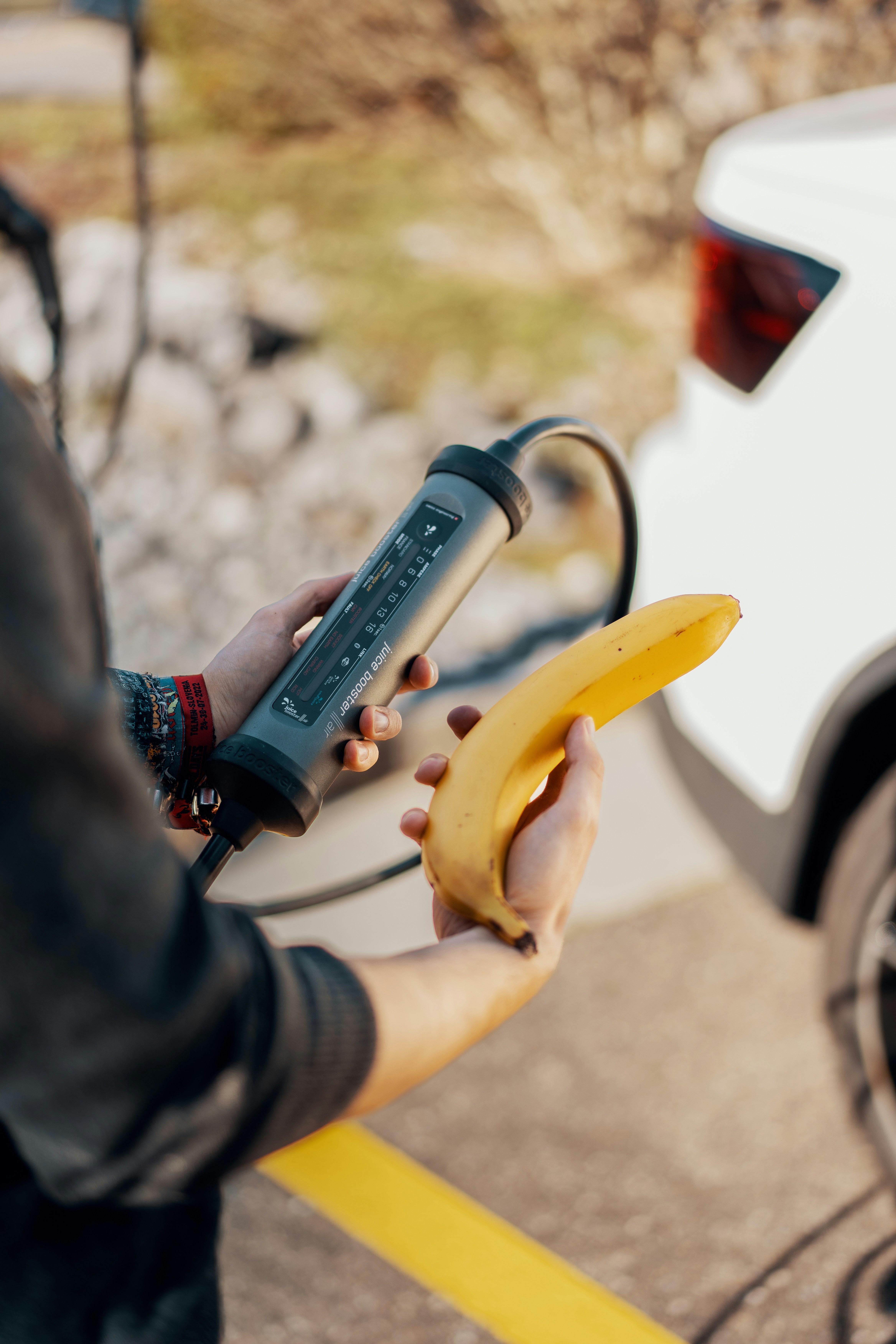 A person is holding a banana in their hand