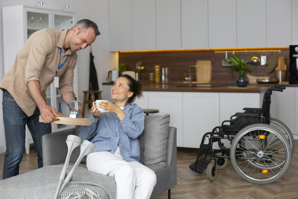 A man and a support worker relaxing in a living room