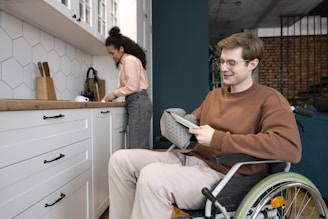 A man in a wheel chair in a kitchen