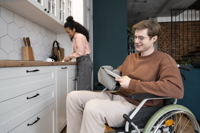 A man in a wheel chair in a kitchen